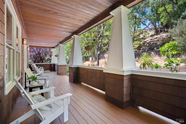 a living room with furniture fireplace and a large window