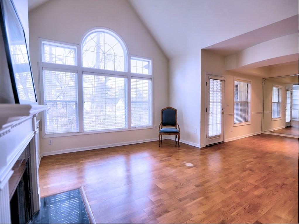3636 Habersham Road Northwest, Unit 2308 Atlanta, GA 30305 - Photo 2 of 42 wooden floor fireplace and windows in an empty room