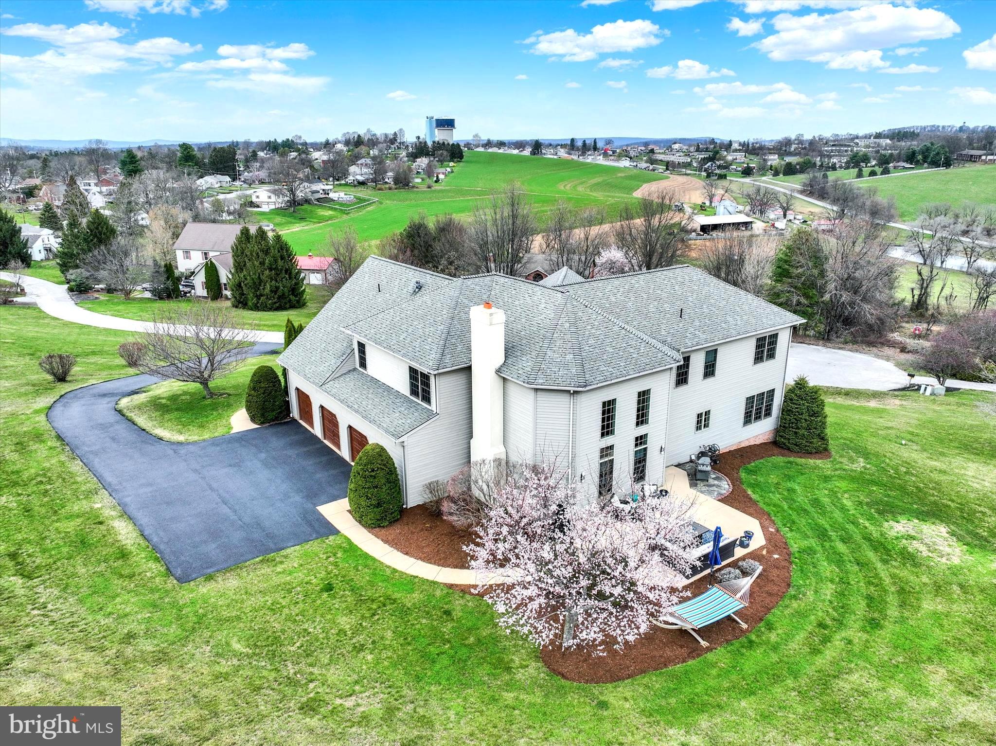 an aerial view of a house with garden space and street view