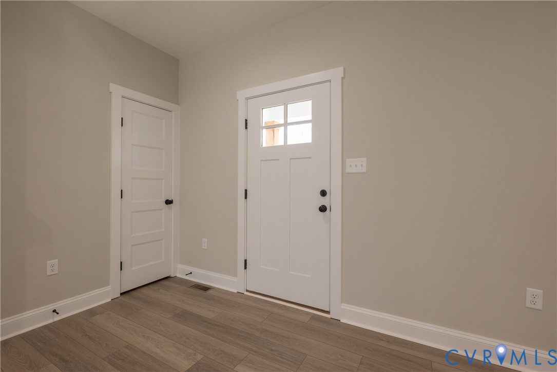 2223 Ridge Road Arvonia, VA 23004 - Photo 11 of 45 a view of an empty room with wooden floor and a window