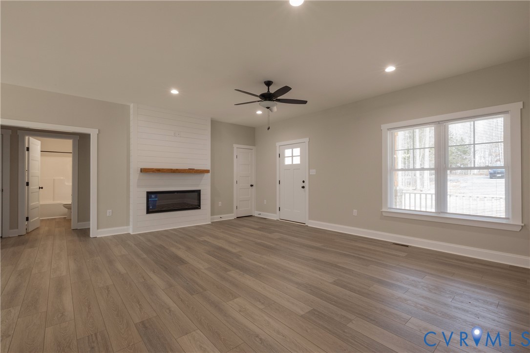 2223 Ridge Road Arvonia, VA 23004 - Photo 14 of 45 an empty room with windows and a fireplace