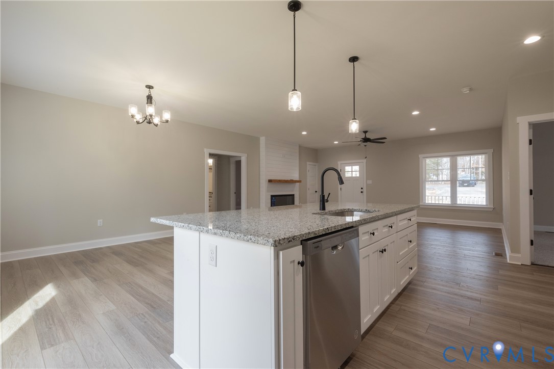 2223 Ridge Road Arvonia, VA 23004 - Photo 17 of 45 a kitchen with granite countertop a sink cabinets and wooden floor