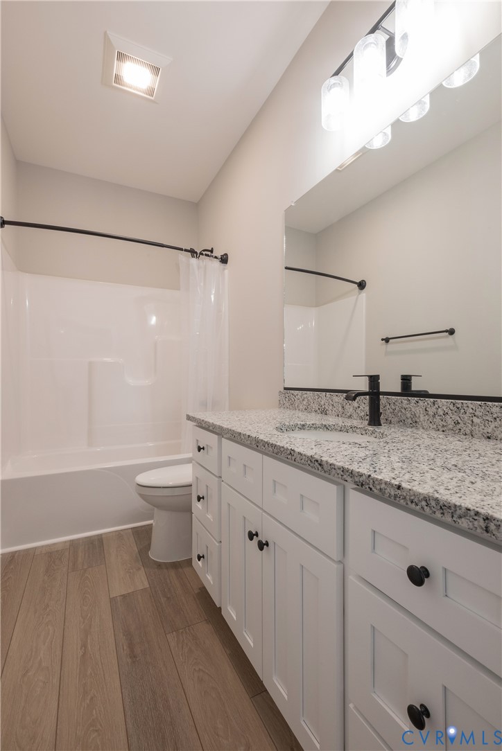 2223 Ridge Road Arvonia, VA 23004 - Photo 24 of 45 a bathroom with a granite countertop sink mirror vanity and toilet