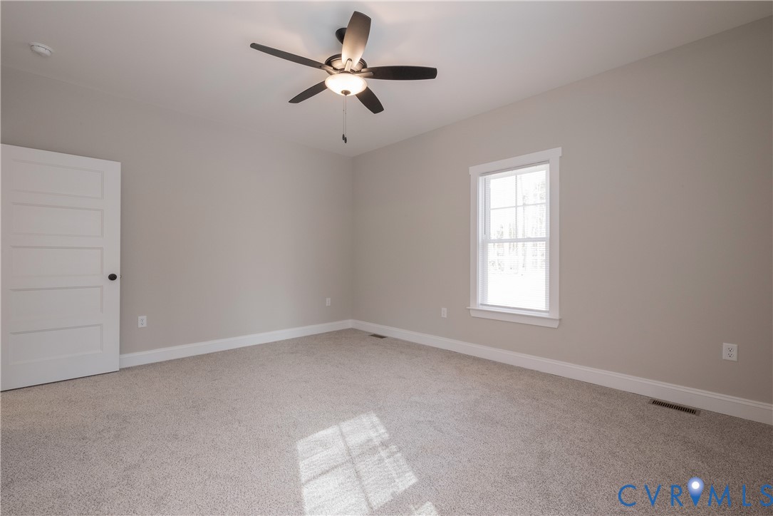 2223 Ridge Road Arvonia, VA 23004 - Photo 27 of 45 an empty room with a window and a fan
