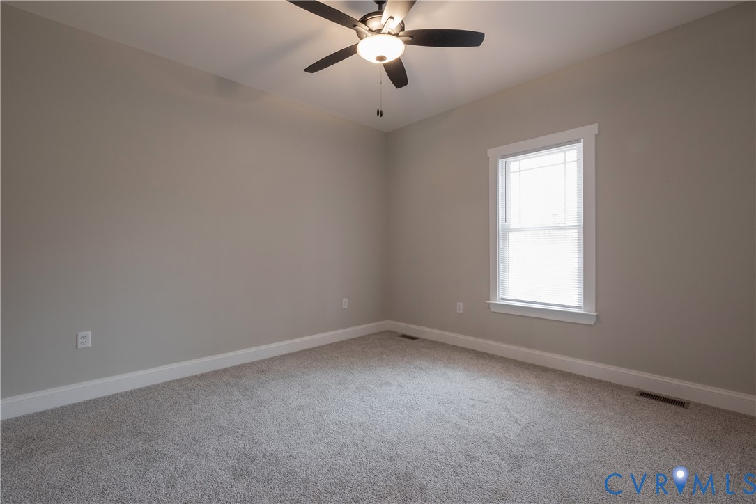 2223 Ridge Road Arvonia, VA 23004 - Photo 31 of 45 an empty room with a window and a fan