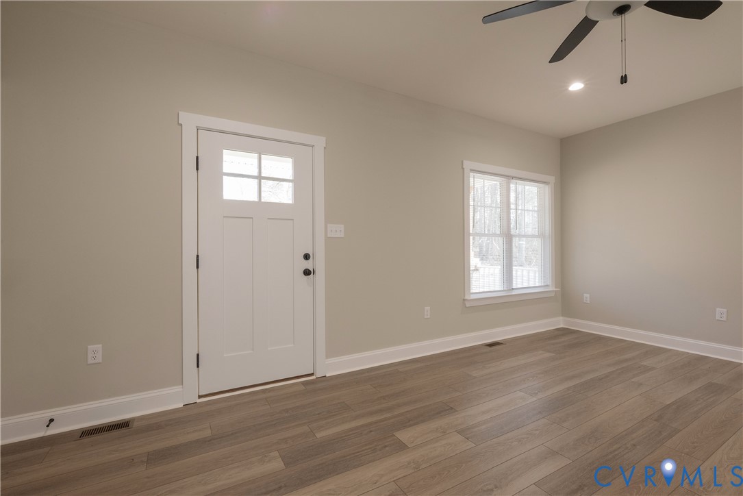 2223 Ridge Road Arvonia, VA 23004 - Photo 35 of 45 an empty room with wooden floor cabinet and windows