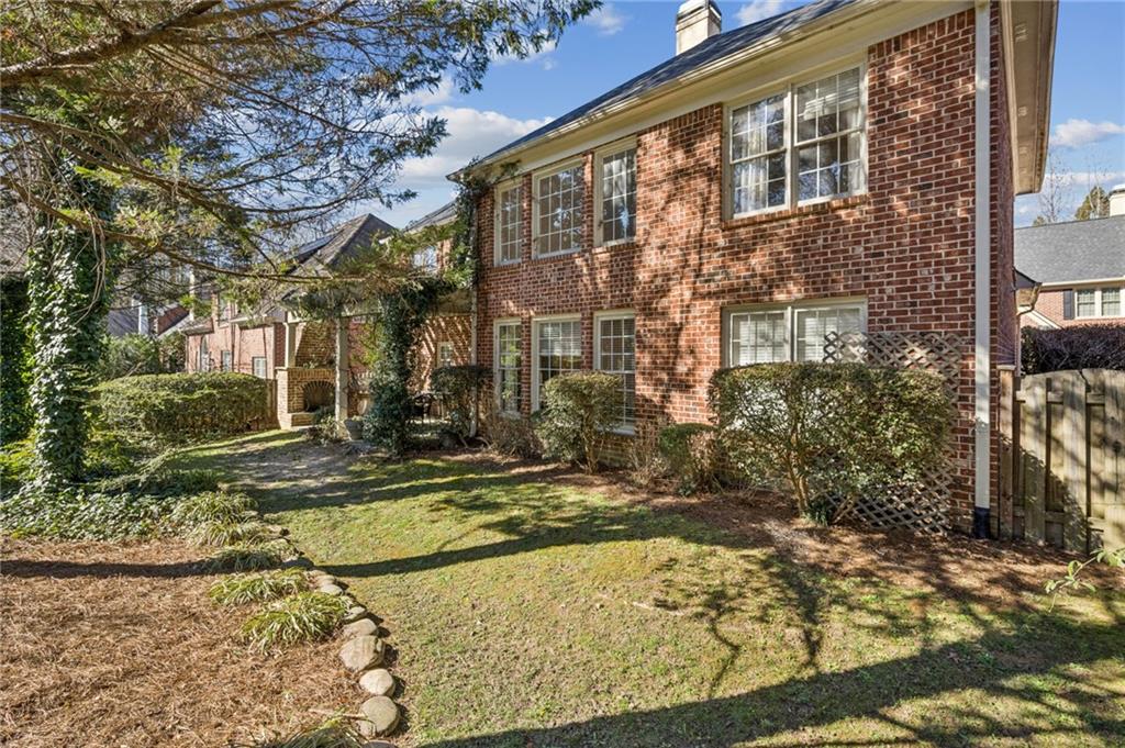 1055 Brookhaven Walk Northeast Atlanta, GA 30319 - Photo 12 of 40 a view of a brick building next to a yard