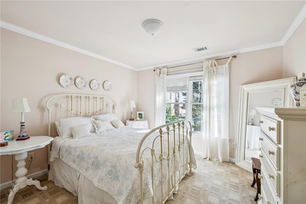 1055 Brookhaven Walk Northeast Atlanta, GA 30319 - Photo 14 of 40 a bedroom with a bed and a mirror