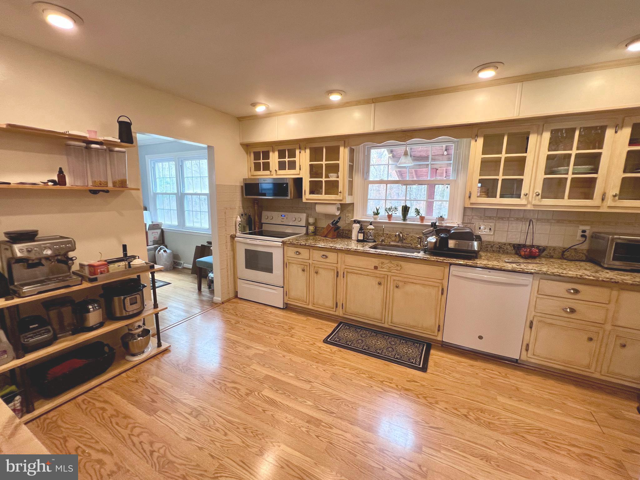 2418 Marilyn Drive Wilmington, DE 19810 - Photo 11 of 46 a large kitchen with stainless steel appliances granite countertop a stove and cabinets