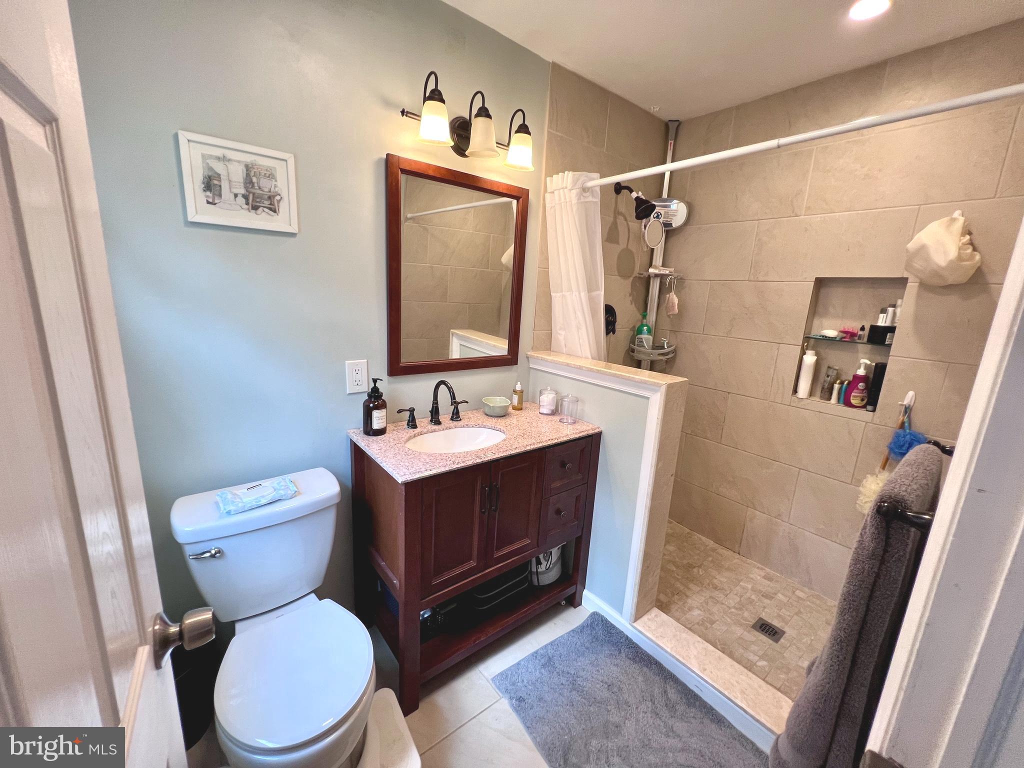 2418 Marilyn Drive Wilmington, DE 19810 - Photo 16 of 46 a bathroom with a toilet sink and shower