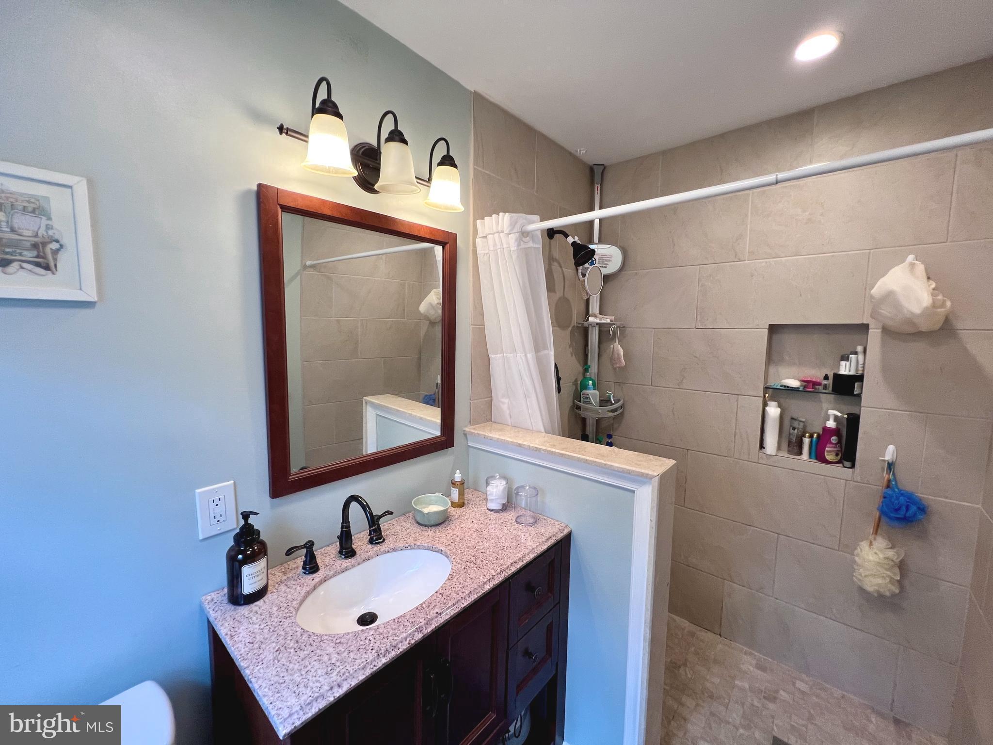 2418 Marilyn Drive Wilmington, DE 19810 - Photo 17 of 46 a bathroom with a sink vanity and a mirror