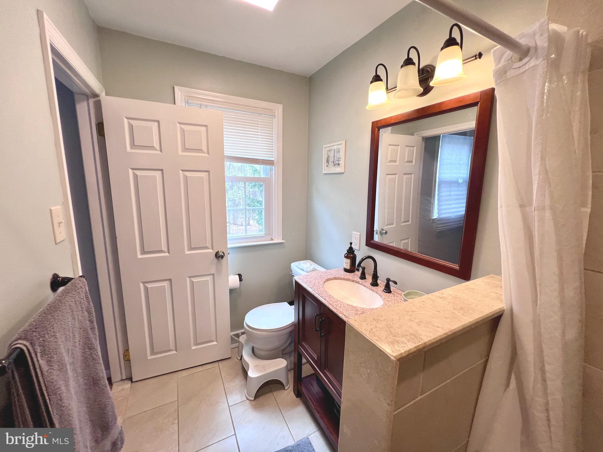 2418 Marilyn Drive Wilmington, DE 19810 - Photo 18 of 46 a bathroom with a sink vanity granite and a mirror