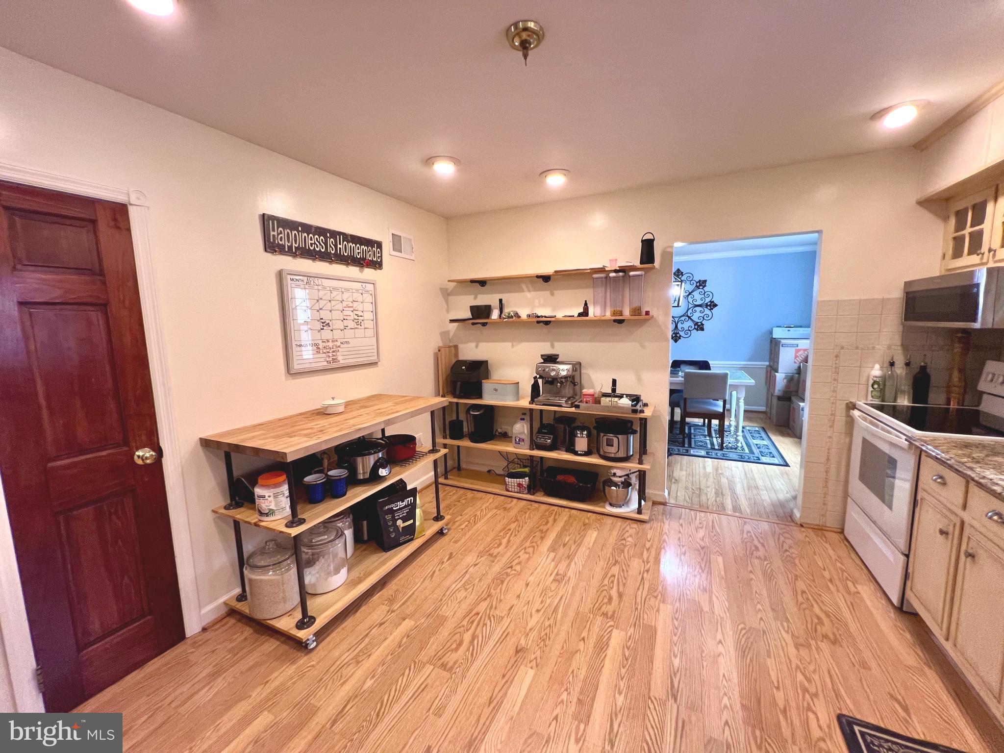 2418 Marilyn Drive Wilmington, DE 19810 - Photo 20 of 46 a kitchen with stainless steel appliances a stove and wooden floor