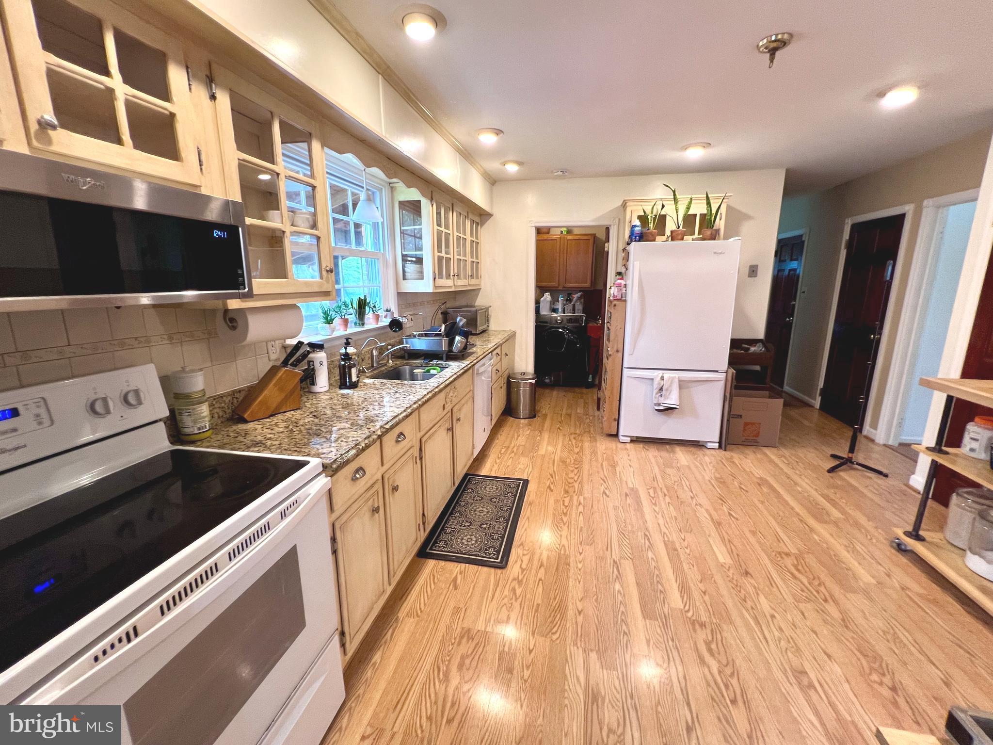 2418 Marilyn Drive Wilmington, DE 19810 - Photo 10 of 46 a kitchen with stainless steel appliances granite countertop a refrigerator a stove and a wooden floors
