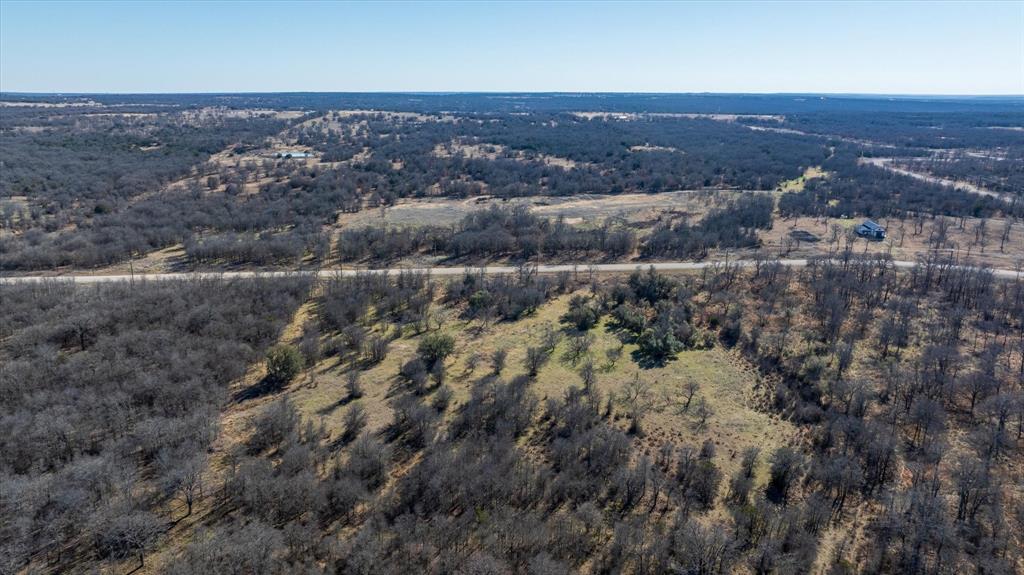 Lot 27 Paradise Oaks Ranch Perrin, TX 76486 - Photo 12 of 21 an aerial view of house with yard and mountain view in back