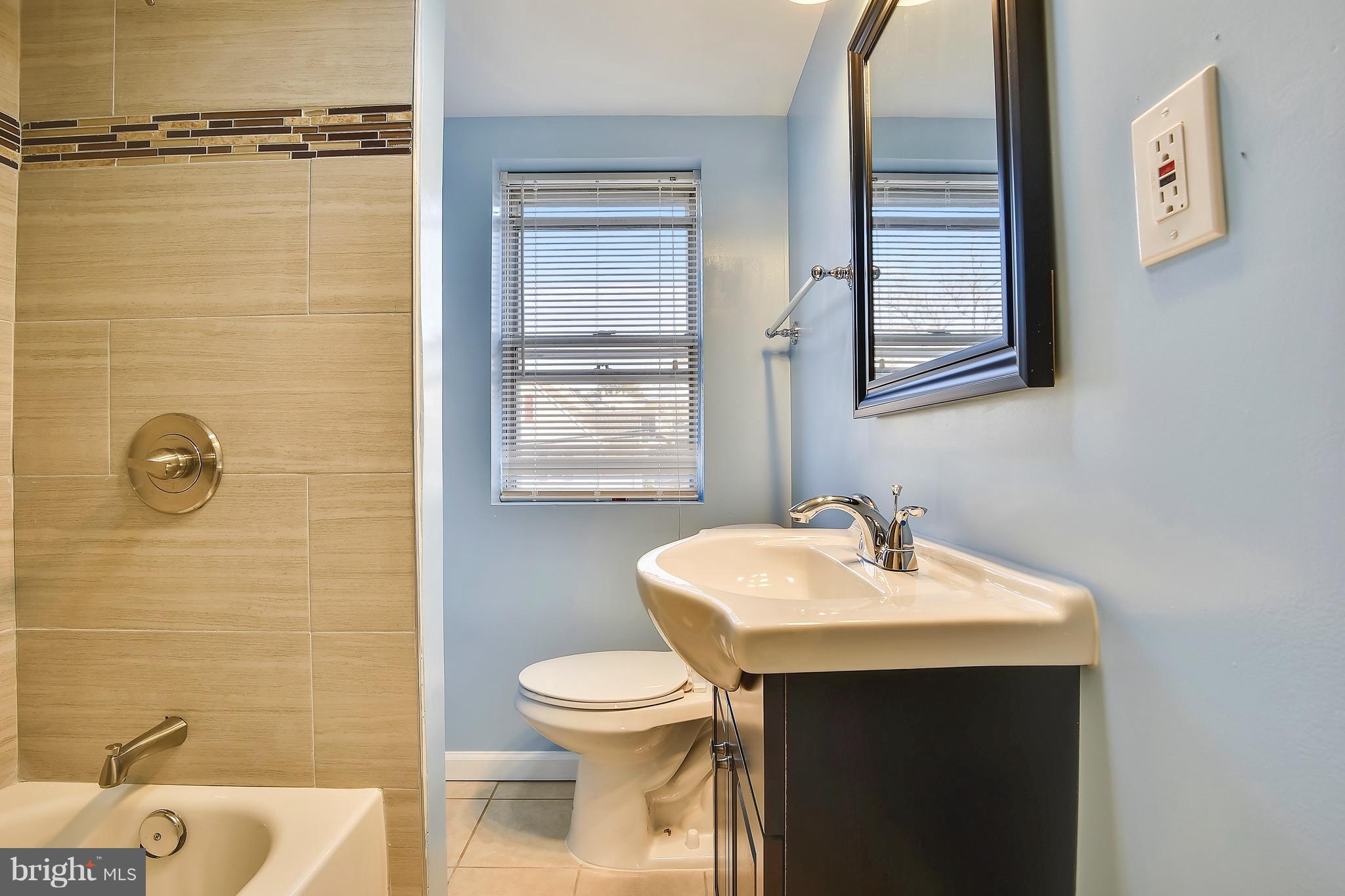 227 Old Riverside Road Baltimore, MD 21225 - Photo 14 of 20 a bathroom with a sink toilet and mirror