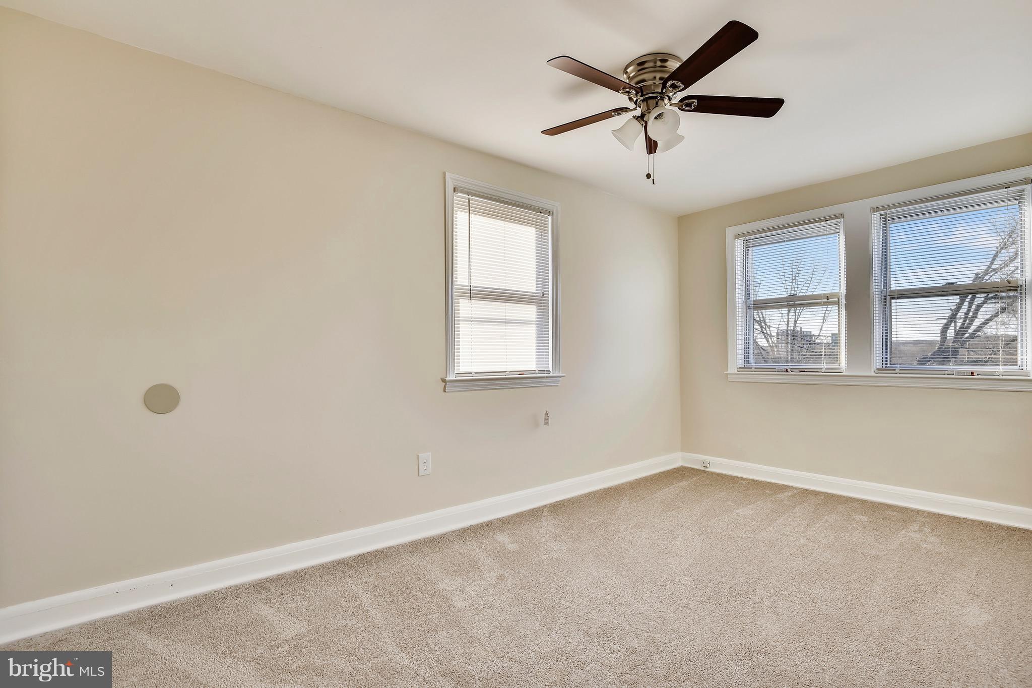 227 Old Riverside Road Baltimore, MD 21225 - Photo 17 of 20 an empty room with windows and ceiling fan