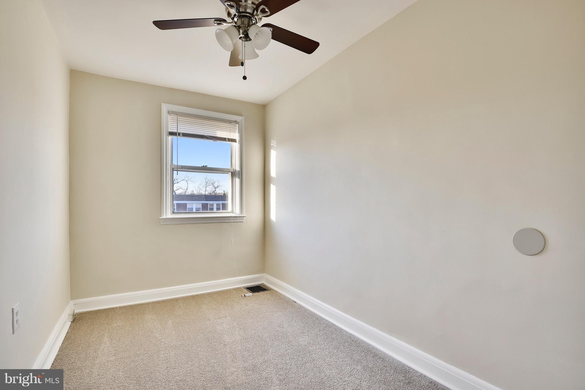 227 Old Riverside Road Baltimore, MD 21225 - Photo 19 of 20 an empty room with a window and a fan