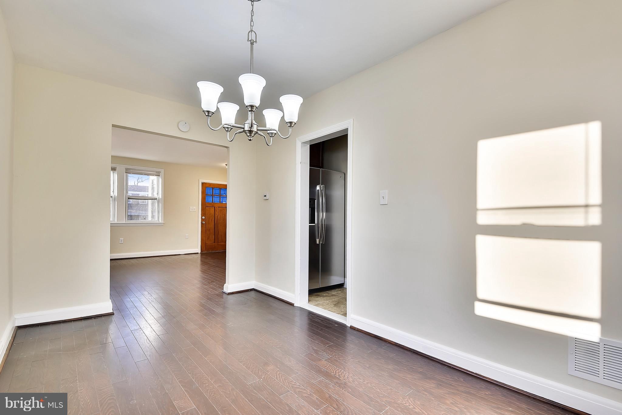 227 Old Riverside Road Baltimore, MD 21225 - Photo 3 of 20 a view of a room with wooden floor chandelier and a window