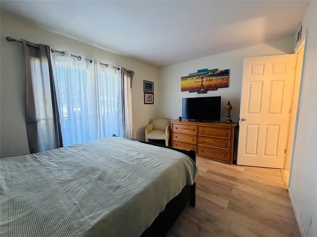a bedroom with a bed and flat screen tv