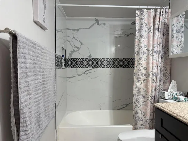 a bathroom with a bathtub and shower