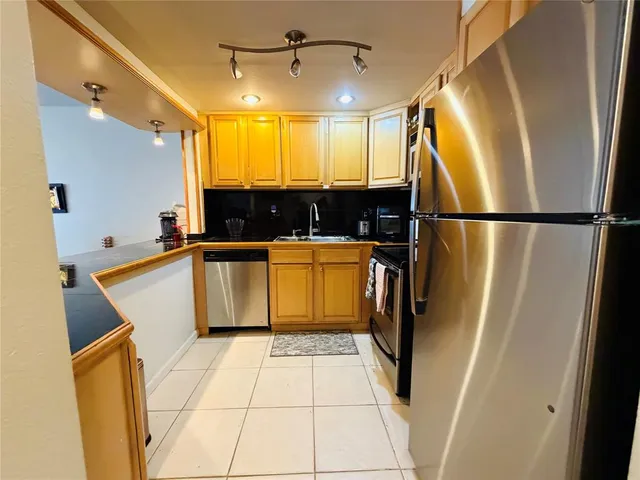 a view of a kitchen with a refrigerator