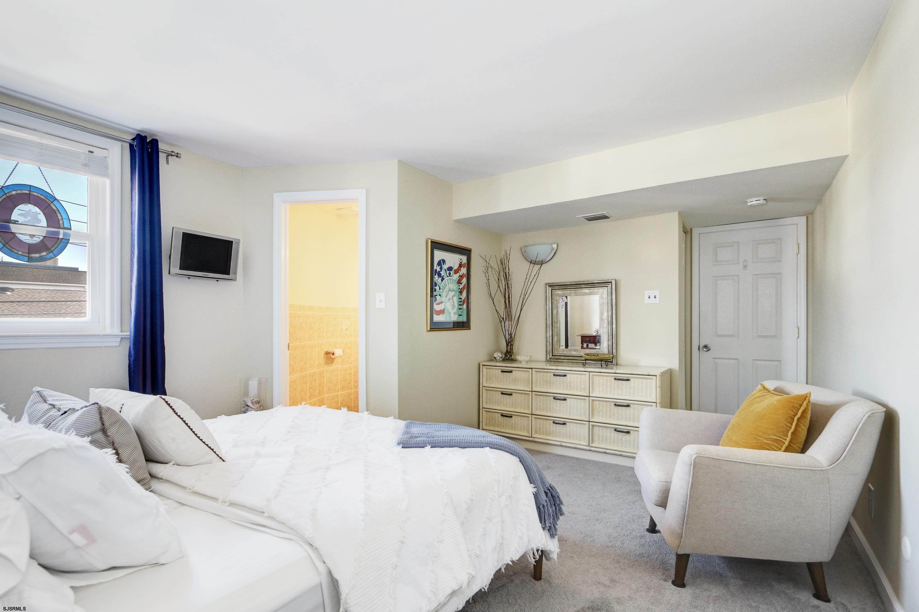 9801 Ventnor Avenue, Unit B1 Margate City, NJ 08402 - Photo 11 of 23 a bedroom with a bed and a couch