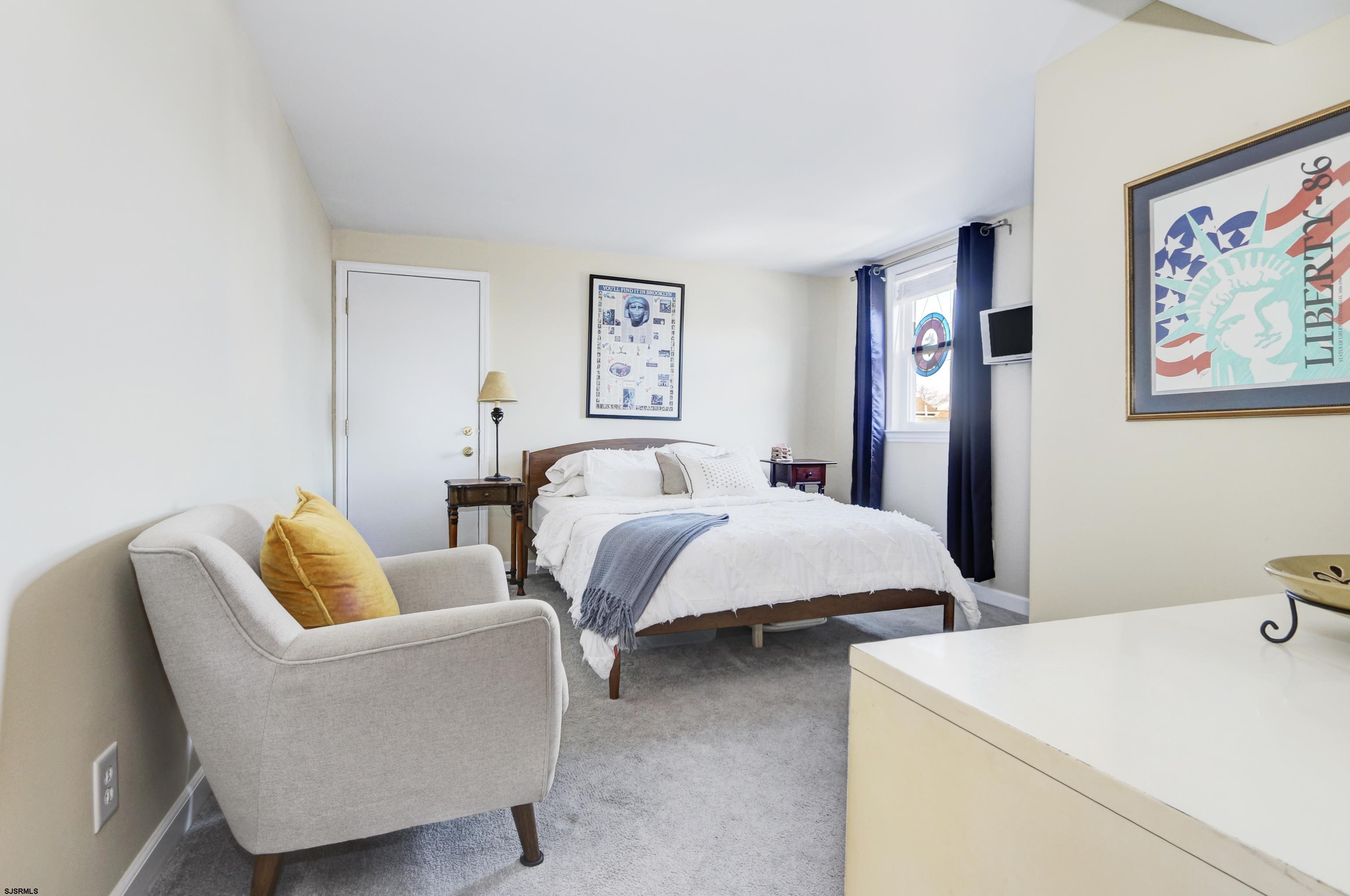 9801 Ventnor Avenue, Unit B1 Margate City, NJ 08402 - Photo 13 of 23 a bedroom with bed and couch