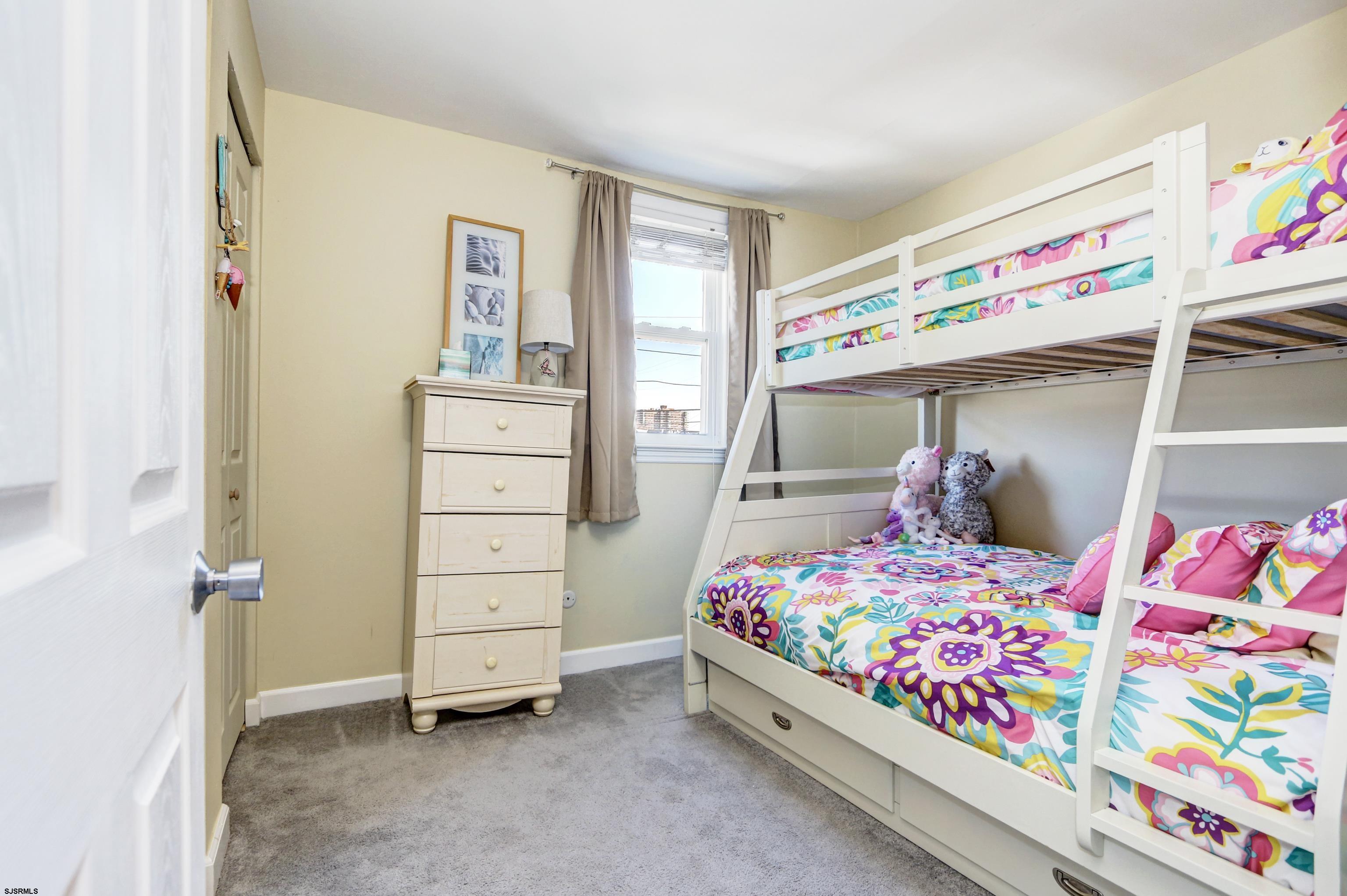 9801 Ventnor Avenue, Unit B1 Margate City, NJ 08402 - Photo 15 of 23 a bedroom with a bed and wooden floor