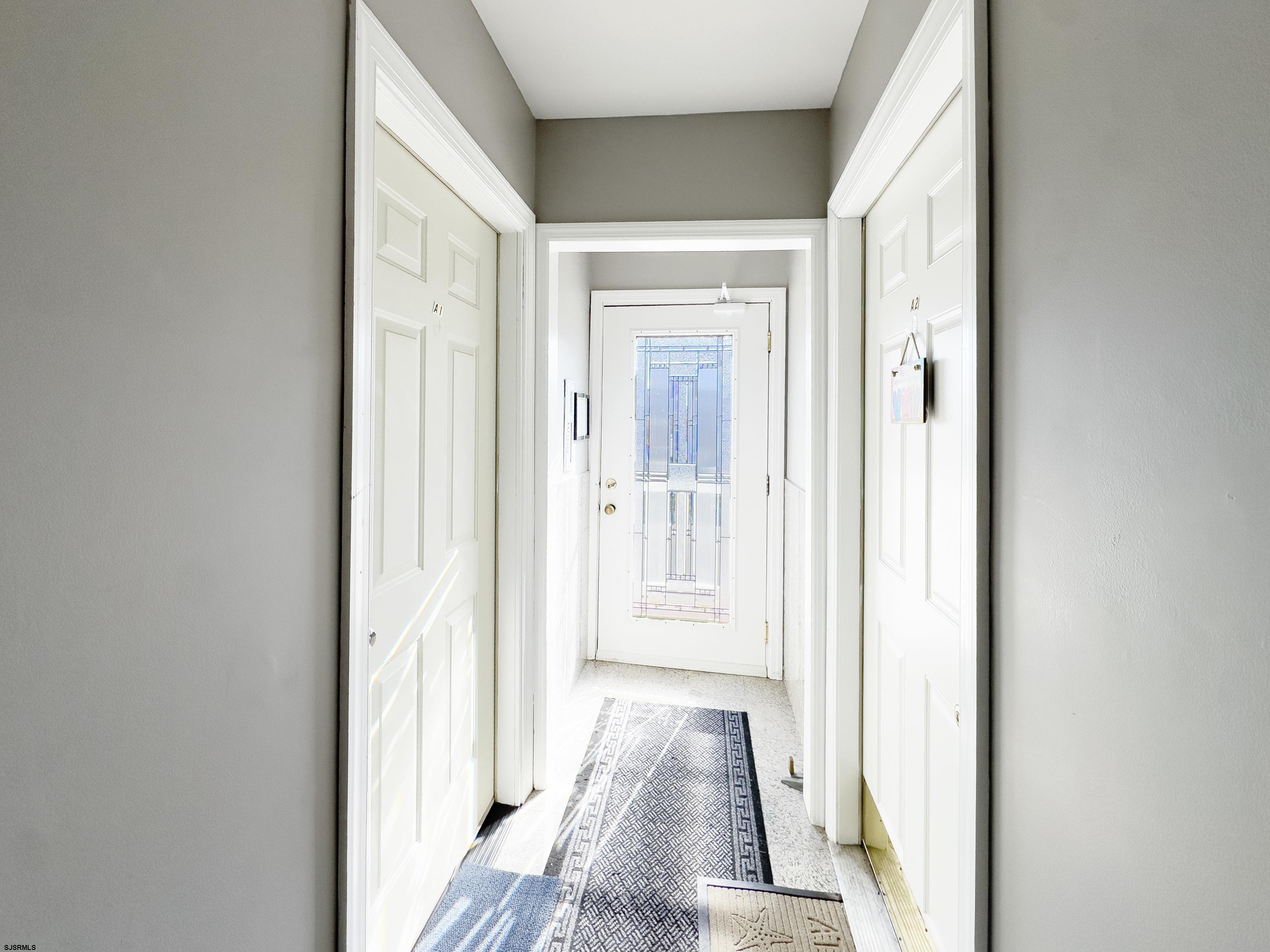 9801 Ventnor Avenue, Unit B1 Margate City, NJ 08402 - Photo 19 of 23 a view of a hallway with wooden floor and a bathroom