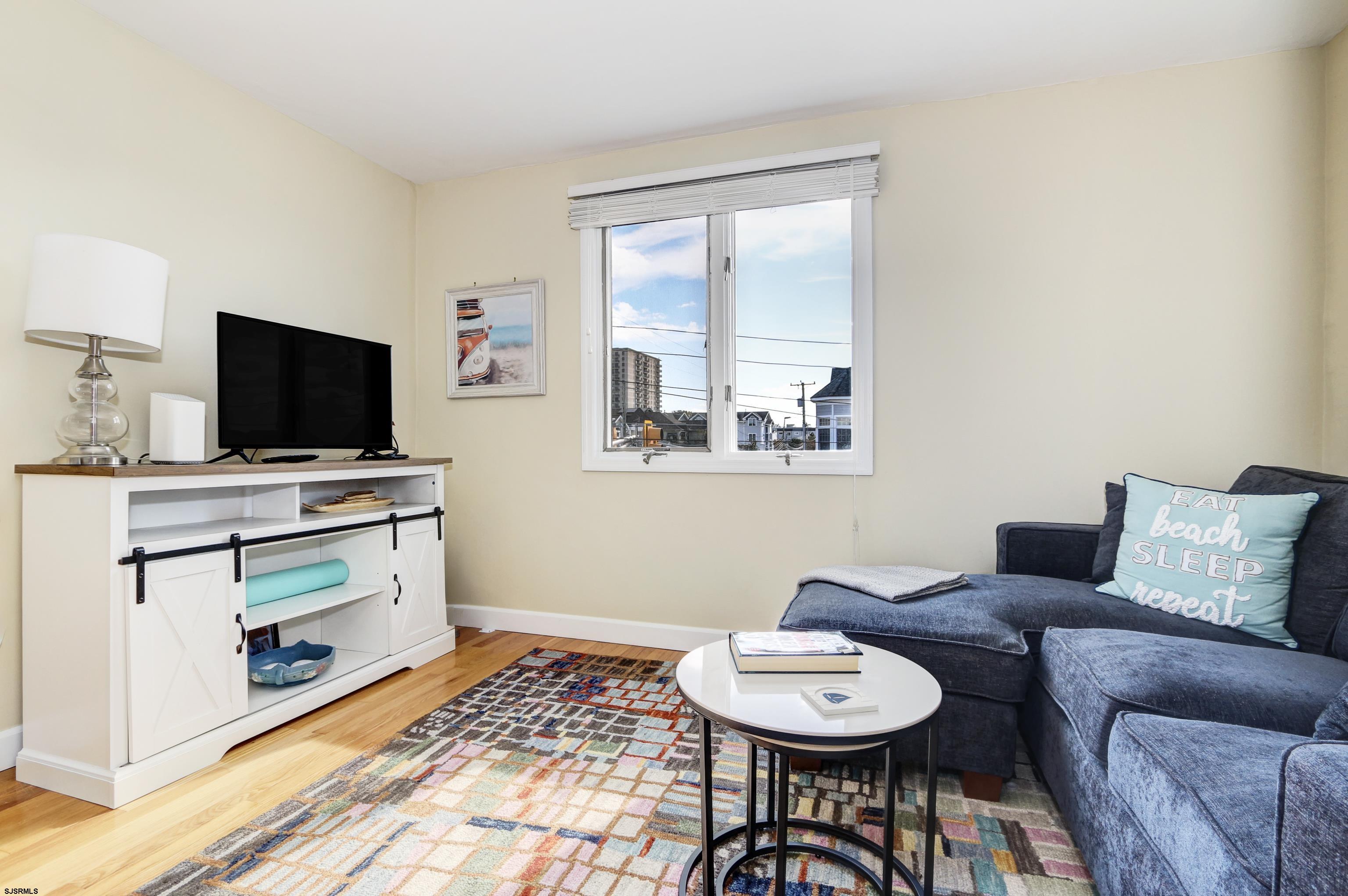 9801 Ventnor Avenue, Unit B1 Margate City, NJ 08402 - Photo 10 of 23 a living room with furniture and a flat screen tv
