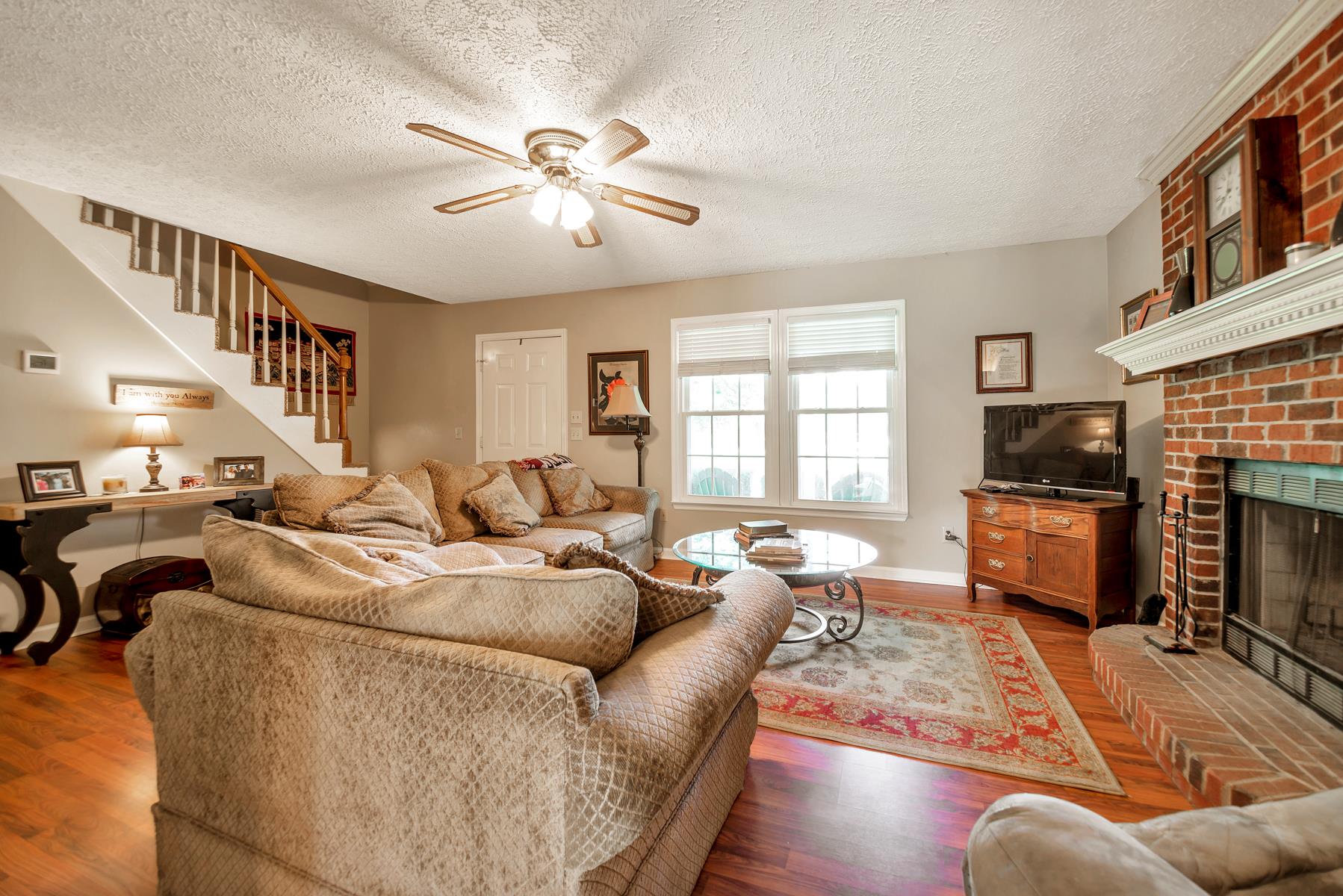 Living room with wood burning fireplace.