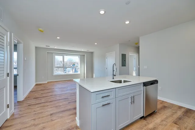 a kitchen with a sink and cabinets