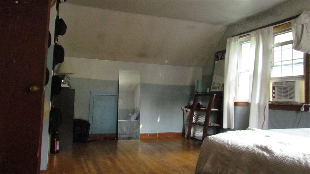 157 Wapping Road Kingston, MA 02364 - Photo 13 of 14 a bedroom with a bed and wooden floor