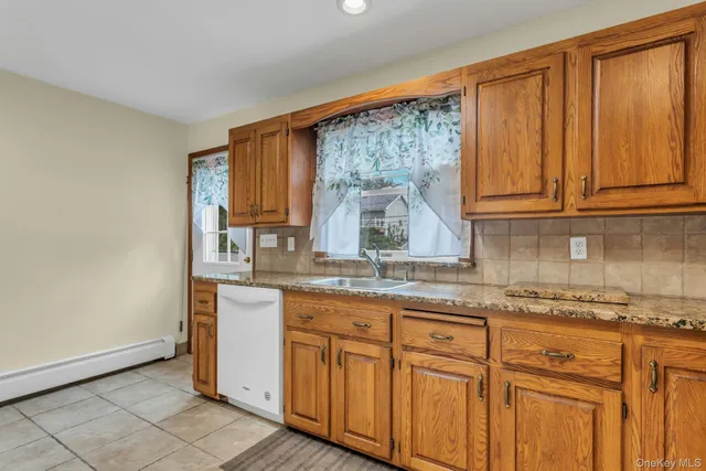 a kitchen with a refrigerator a stove top oven and cabinets