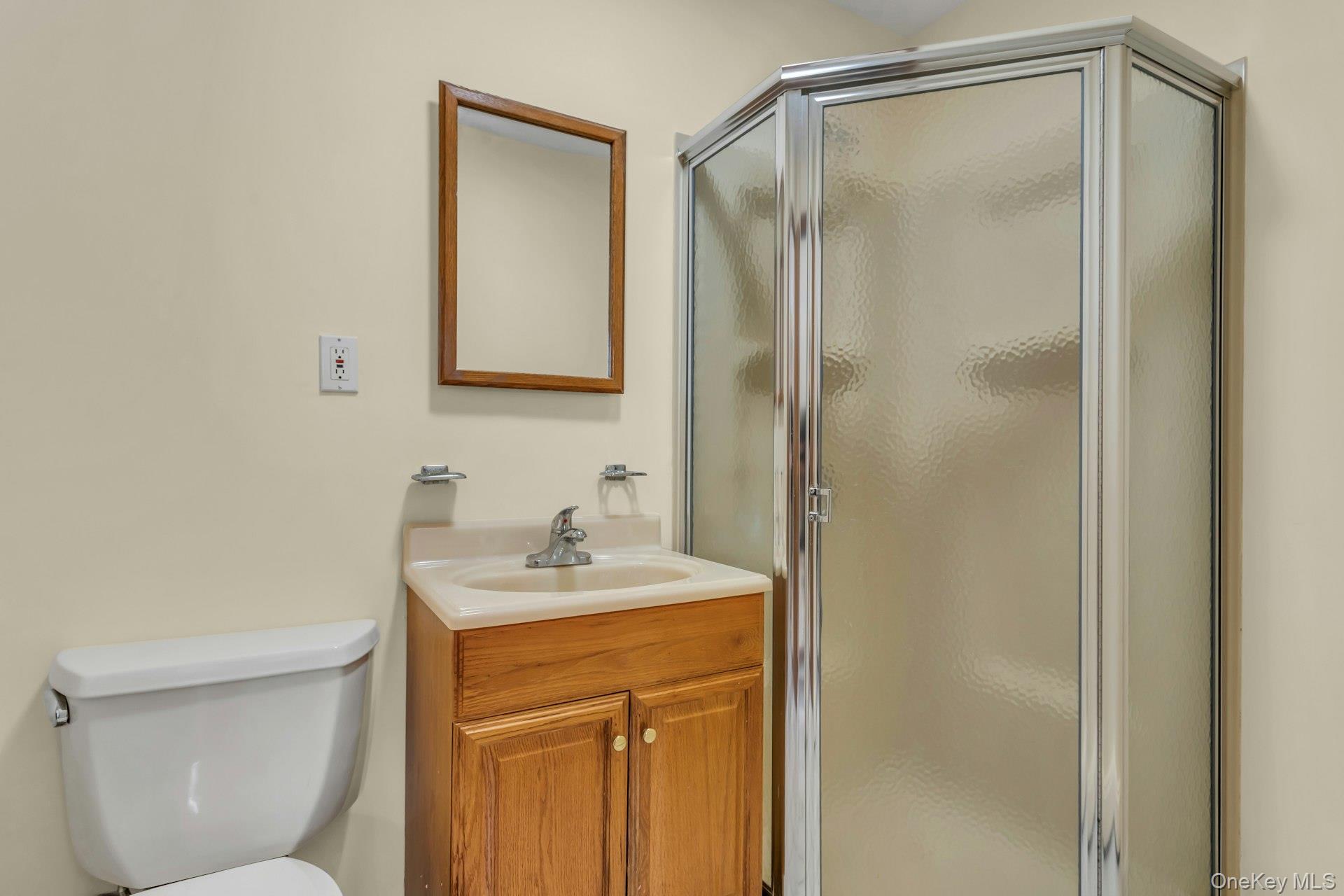 4 Timber Road Glen Cove, NY 11542 - Photo 13 of 30 a bathroom with a sink a toilet and shower