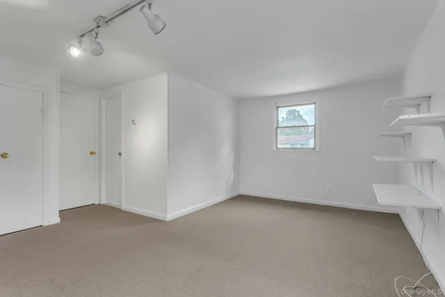 an empty room with a empty space and windows