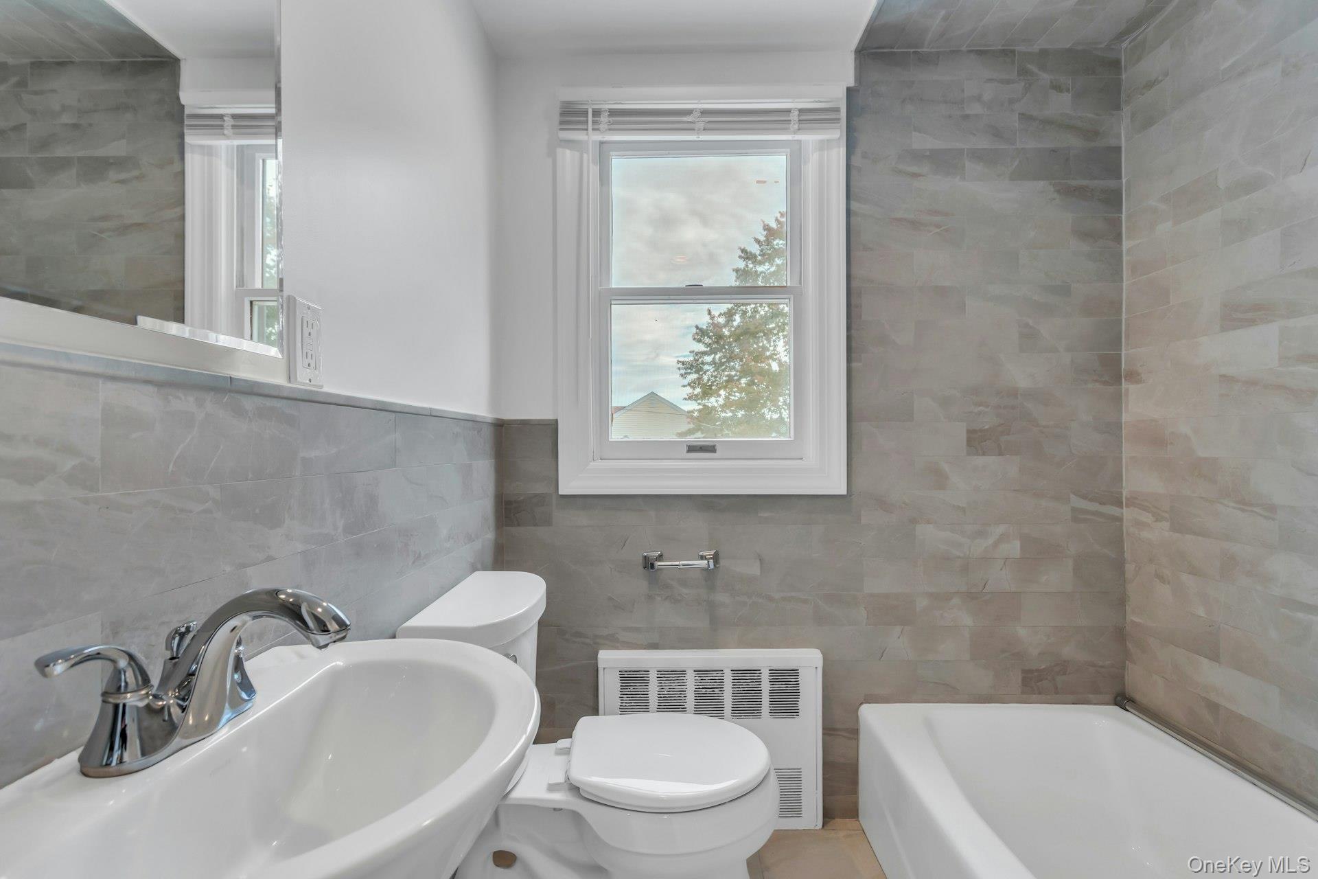 4 Timber Road Glen Cove, NY 11542 - Photo 22 of 30 a bathroom with a sink a toilet and bathtub