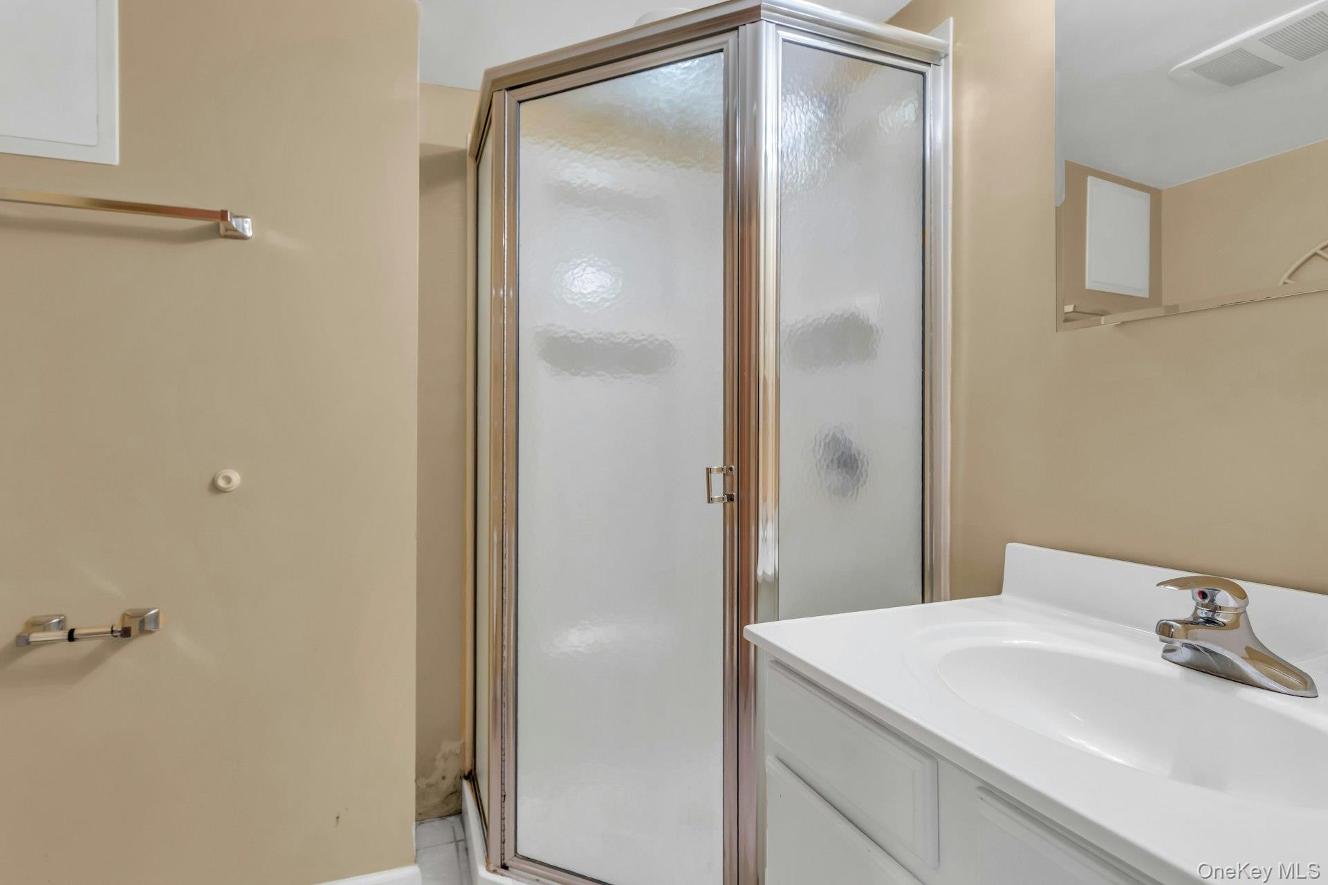 4 Timber Road Glen Cove, NY 11542 - Photo 26 of 30 a bathroom with a sink and mirror