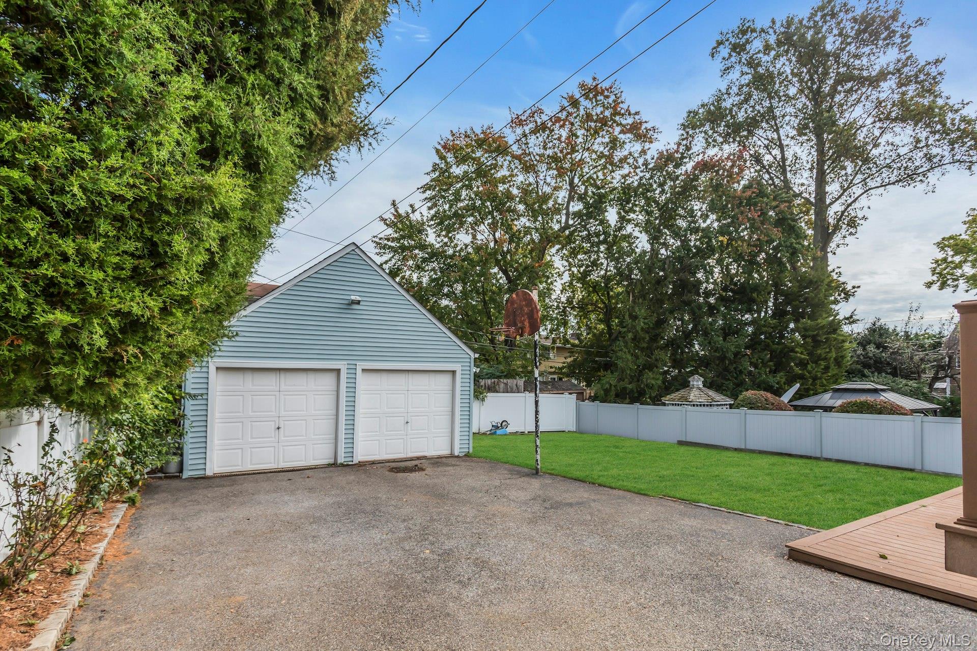 4 Timber Road Glen Cove, NY 11542 - Photo 27 of 30 a house with trees in the background