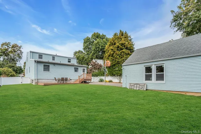 a view of a house with a yard and sitting area