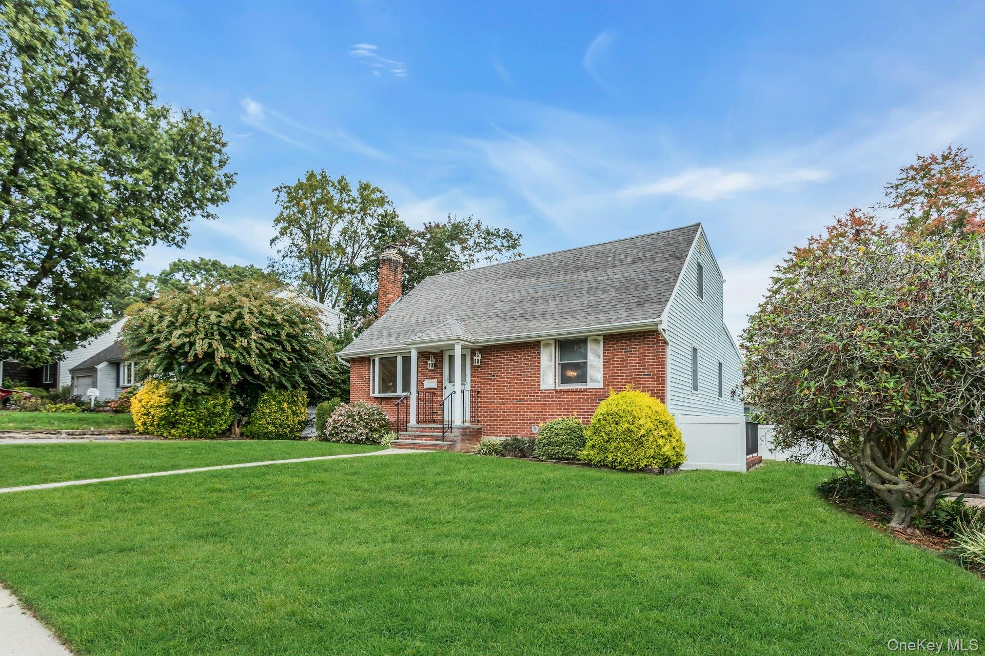 4 Timber Road Glen Cove, NY 11542 - Photo 3 of 30 a view of a house with a yard and potted plants