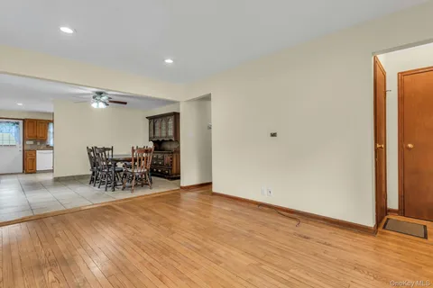 a view of a room with furniture and wooden floor