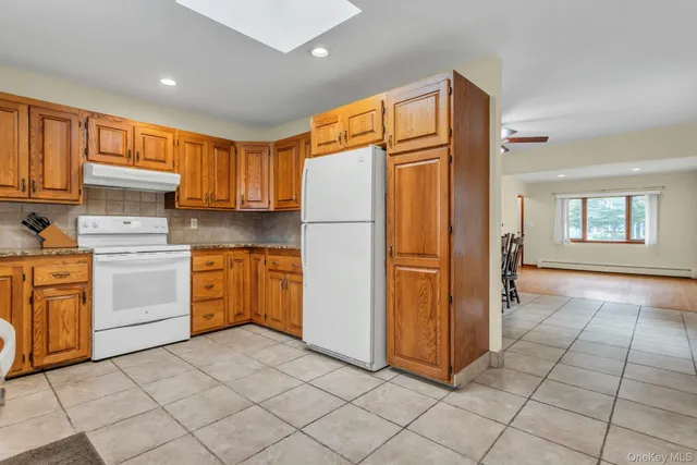 a kitchen with a stove sink and cabinets