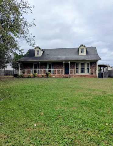 a front view of a building with a garden