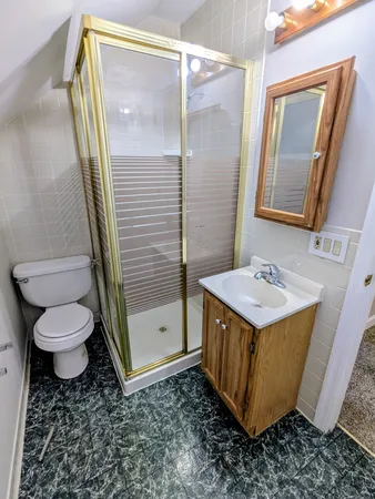 a bathroom with a sink a toilet and mirror