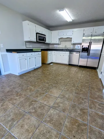 a kitchen with stainless steel appliances a stove a sink and a counter top space