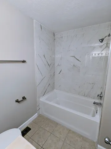 a bathroom with a bathtub and a shower