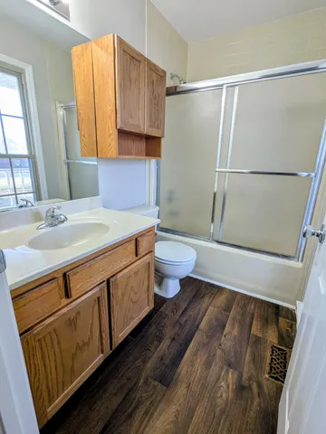 a bathroom with a sink a toilet and shower