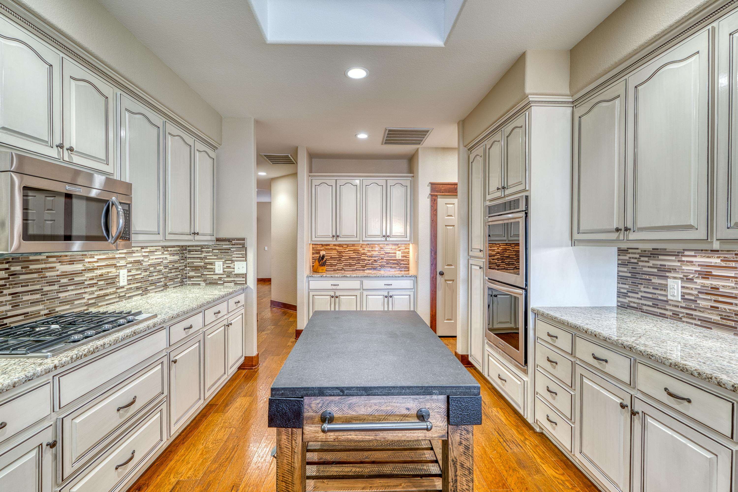 206 River Ranch Road Kingsland, TX 78639 - Photo 12 of 30 a kitchen with stainless steel appliances granite countertop a stove and a refrigerator